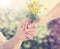 Elderly and young woman holding flowers outside