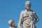 Elderly and young â€“ old sculpture of engineer and his scholar on Zoll Bridge in Magdeburg downtown at blue sky background,