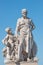 Elderly and young â€“ old sculpture of engineer and his scholar on Zoll Bridge in Magdeburg downtown at blue sky background,