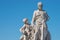 Elderly and young â€“ old sculpture of engineer and his scholar on Zoll Bridge in Magdeburg downtown at blue sky background,