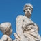 Elderly and young â€“ old sculpture of engineer and his scholar on Zoll Bridge in Magdeburg downtown at blue sky background,