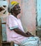 Elderwoman on front porch of abode in Haiti.