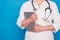 Eldery caucasian doctor lady in white coat and with stethoscope and tablet on blue background. Emotional portraits