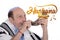 Eldery jewish man blowing the Shofar horn