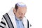 Eldery jewish man wrapped in talit praying