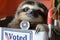The elections. A sloth is in a box labeled as voted, sitting idly