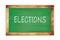 ELECTIONS text written on green school board