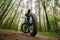 Electric bike with thick wheels on the background of a forest. Pleasant sports hobby. Black fatbike