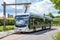 Electric bus being recharged while stationary at a bus stop