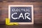 Electric Car. Batteries, accumulators and chalk board on a wooden table