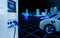 Electric car and EV car charging station with cityscape background in futuristic vehicle concept. Electric vehicle in smart city