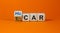 Electric car or a hydrogen car. Turned a cube and changed words `H2 car` to `E-car`. Beautiful orange background, copy space.