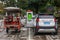 An electric car and popular tricycles truck scooter charging on the street in tourist city Yangshuo of China.