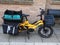 An electric cargo bike with pannier bags and crates