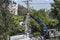 Electric company team working on a transmission tower using two truck lifts