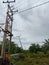 electric control panel and electric pole with blue sky backdrop