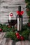 Electric corkscrew in steel gray. Near a glass and a bottle of wine. The bottle is decorated with a red bow. Gray wooden