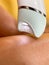 Electric depilator epilator in a female hand. Hair removal from the legs. Real life