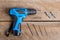 Electric drill on wooden table background and copy space.