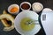 Electric Egg Beater in a Mixing Bowl of Egg White Surrounded with Another Ingredients