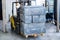 Electric forklift carries boxes.