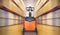 Electric Forklift Pallet Jack in Blurred Warehouse. Shipping Warehouse. Tall Shelf Storage. Supplies Warehouse. Logistics