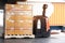 Electric forklift pallet jack with large shipment goods pallet.