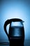 Electric glass tea kettle on blue background