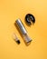 Electric gray metal corkscrew, wine aerator and corkscrew stand. Yellow background .. Top view. Isolated. Hard light and shadow