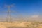 Electric grid lines in desert. Electric transmission lines in the desert