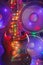 Electric guitar with festive Christmas lights and music speakers in smoke