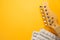 Electric guitar neck closeup with dummy musical score in yellow background