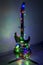 Electric guitar wrapped in colorful garland, the idea of holiday music