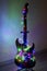 Electric guitar wrapped in colorful garland, the idea of holiday music