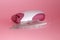 Electric handheld epilator and feather on pink background close up