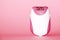 Electric handheld epilator on pink background close up, copy space
