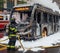 electric hybrid city bus burn bottom chasis, firefighter apply foam to extinguish flames big smoke