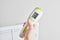 electric infrared thermometer for measuring surface temperature and air on the background of the electric radiator,