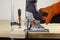 Electric jigsaw. Clamp. Woodworking power tools. Jigsaw in hand. Wooden planks. To the Workshop. On a wooden table. Desktop. Workp