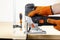 Electric jigsaw. Clamp. Woodworking power tools. Jigsaw in hand. Wooden planks. To the Workshop. On a wooden table. Desktop. Workp