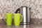 Electric kettle and cups in the kitchen