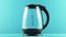 An electric kettle with transparent walls. Boiling. Blue. Concept shot