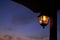 Electric lamp on wooden pile at sunset