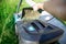 Electric lawn mower Makita. Container with mown mown grass removed from the lawn mower. The green lawn is mowed with a lawn mower