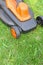 Electric lawnmower on green grass