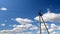 Electric line pylons against a blue sky.