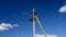 Electric line pylons against a blue sky.