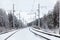 Electric mainline railroad in winter forest