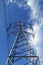 Electric mast pole tower pilot on blue cloud sky