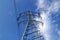 Electric mast pole tower pilot on blue cloud sky